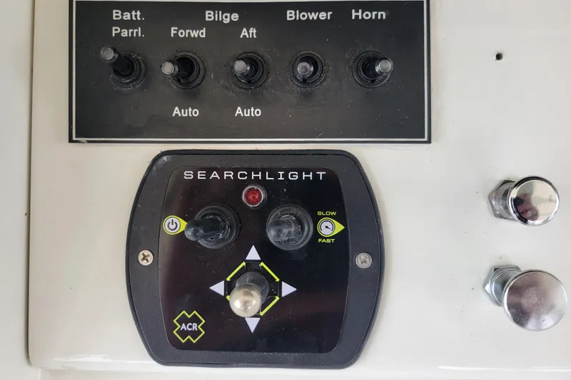 Bout Time Yacht Photos Pics Control panel of a 1979 Bertram 38 Convertible boat with searchlight and switches.
