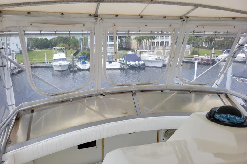 Bout Time Yacht Photos Pics View from 1979 Bertram 38 Convertible yacht helm, overlooking marina with docked boats.