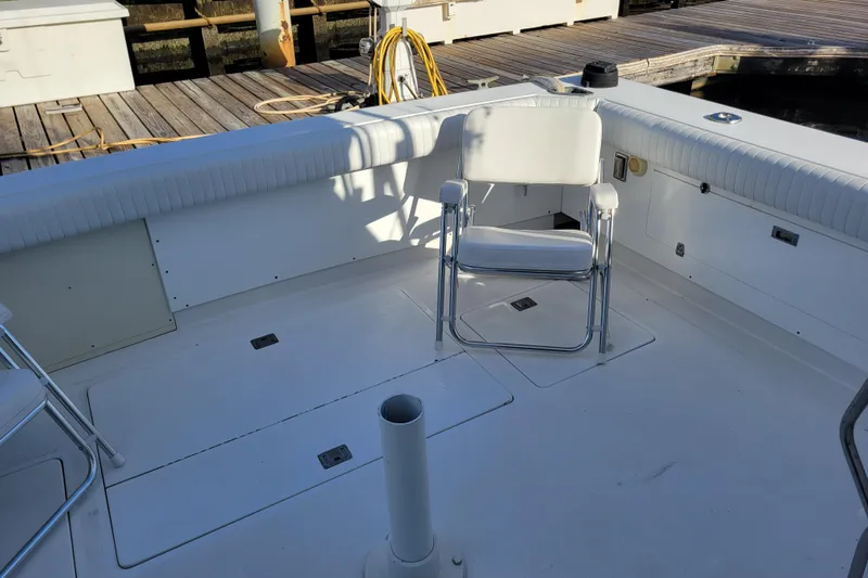 Bout Time Yacht Photos Pics 1979 Bertram 38 Convertible boat deck with white seating and dock view.