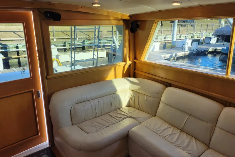 Bout Time Yacht Photos Pics Interior of 1979 Bertram 38 Convertible yacht with cream leather seating and wooden accents.