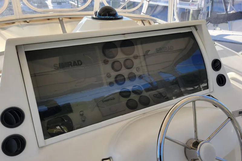 Bout Time Yacht Photos Pics 1979 Bertram 38 Convertible helm with Simrad navigation system and steering wheel.