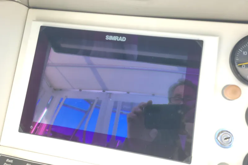 Bout Time Yacht Photos Pics Simrad display on 1979 Bertram 38 Convertible boat dashboard with reflection.