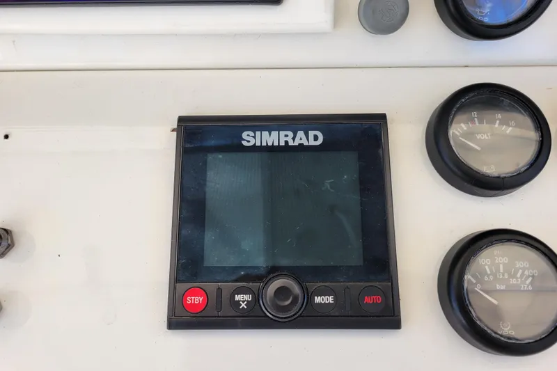 Bout Time Yacht Photos Pics Simrad marine display and gauges on 1979 Bertram 38 Convertible boat dashboard.