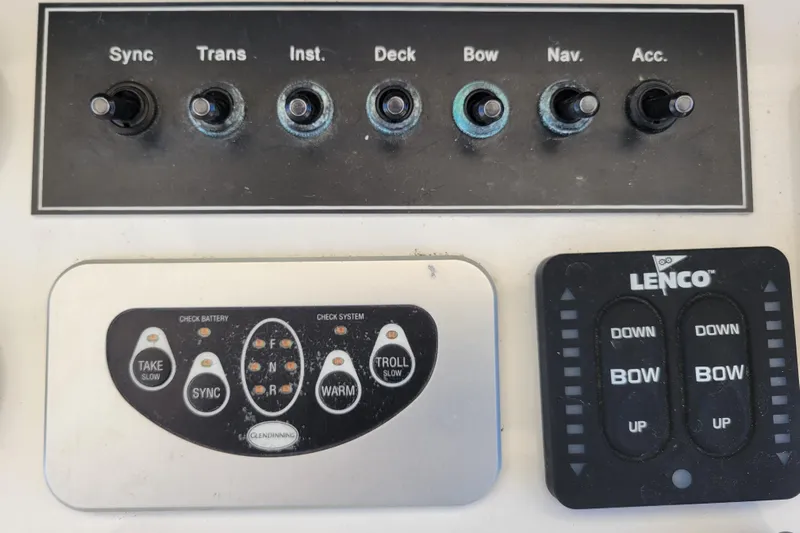 Bout Time Yacht Photos Pics Control panel of a 1979 Bertram 38 Convertible boat with switches and buttons.