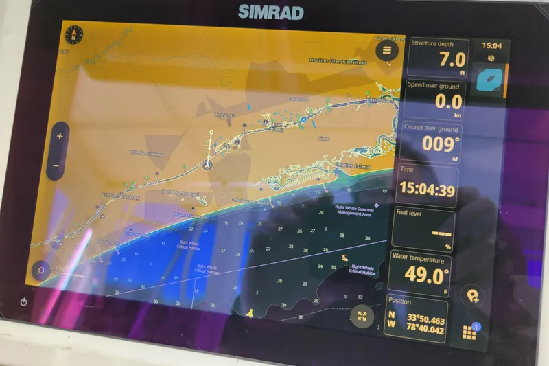 Bout Time Yacht Photos Pics Simrad marine GPS display on 1979 Bertram 38 Convertible, showing navigation and environmental data.