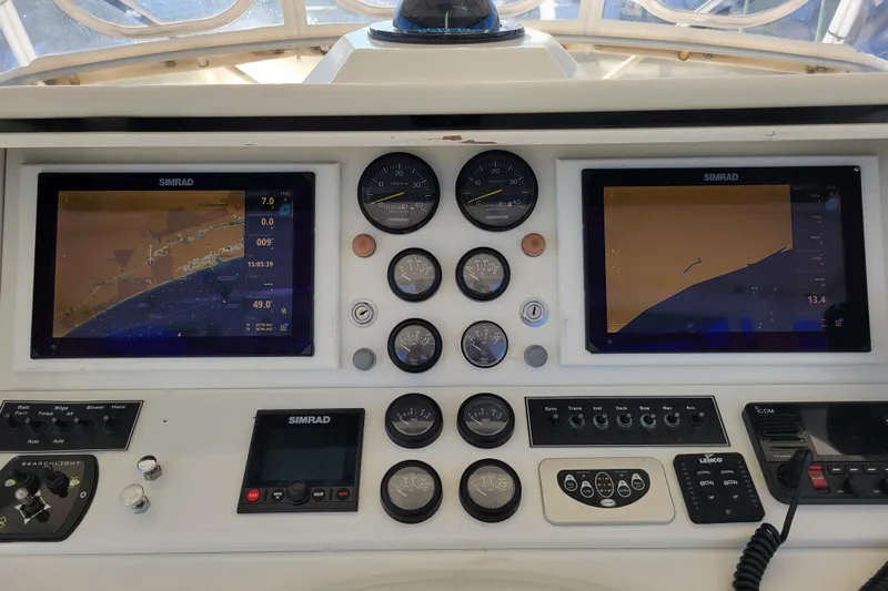 Bout Time Yacht Photos Pics 1979 Bertram 38 Convertible boat dashboard with Simrad navigation displays and gauges.