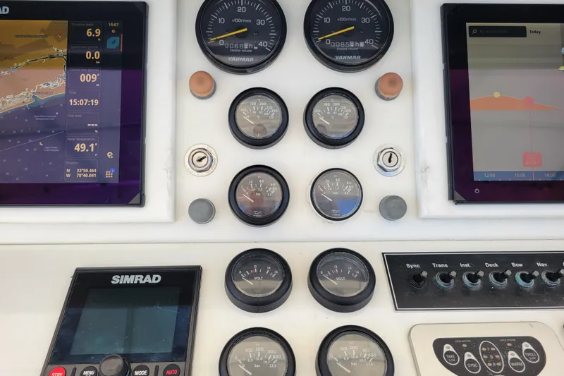 Bout Time Yacht Photos Pics 1979 Bertram 38 Convertible dashboard with navigation screens and gauges.
