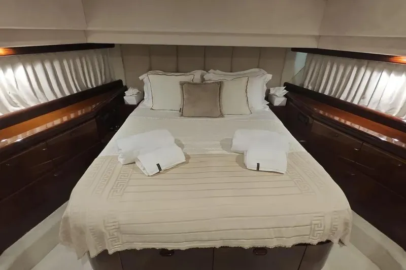  Yacht Photos Pics Luxurious bedroom interior of 2002 Ferretti Yachts 720 with elegant bedding and wood accents.