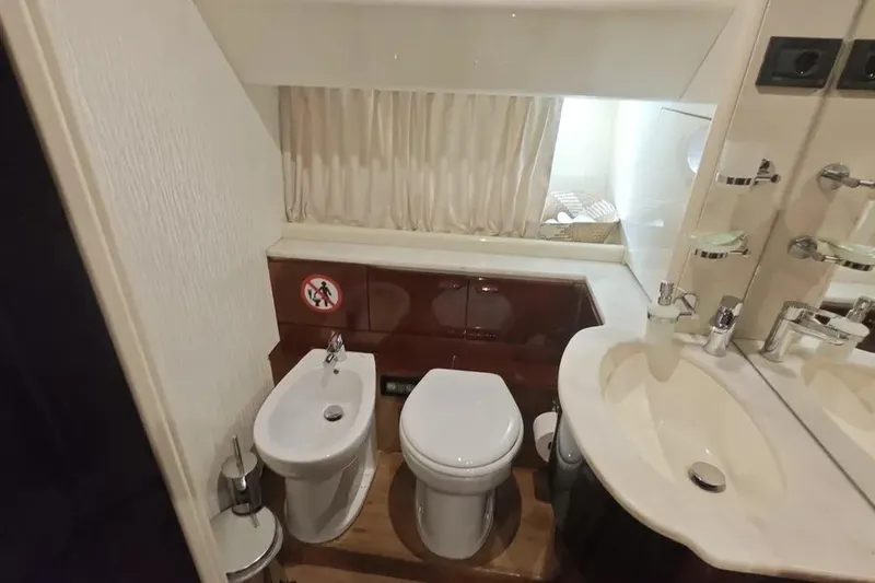  Yacht Photos Pics Luxury bathroom in 2002 Ferretti Yachts 720, featuring toilet, bidet, and elegant fixtures.