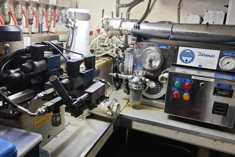  Yacht Photos Pics Engine room of a 2002 Ferretti Yachts 720, featuring complex machinery and control panels.