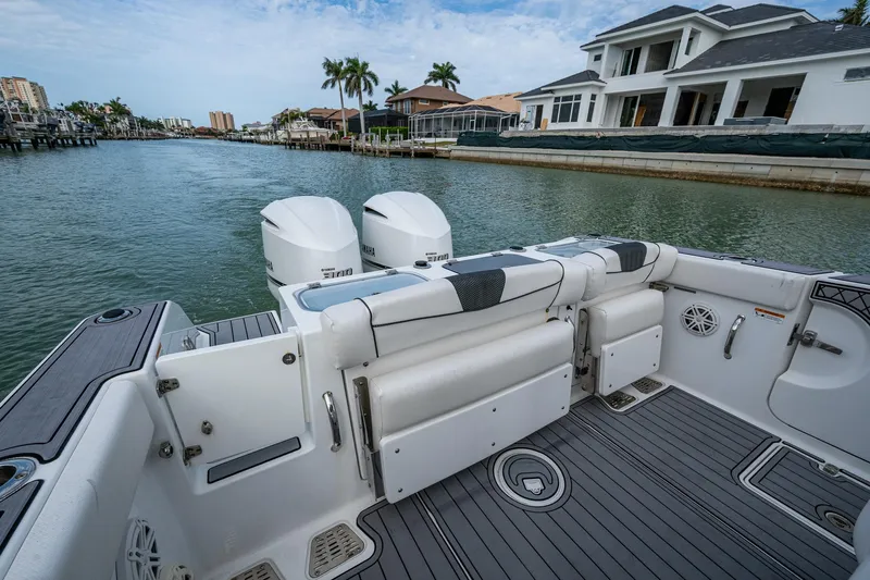  Yacht Photos Pics 2020 Wellcraft 302 Fisherman boat with dual engines docked by waterfront homes.