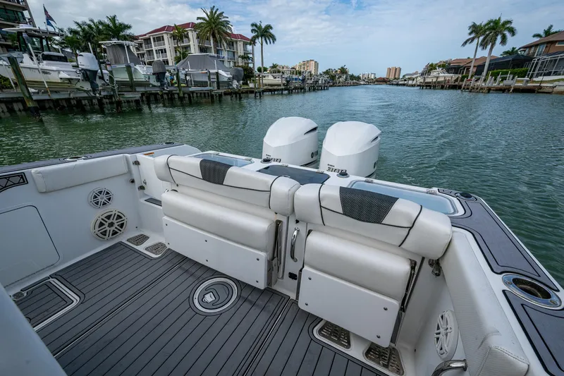  Yacht Photos Pics 2020 Wellcraft 302 Fisherman boat with dual engines docked in a scenic marina.