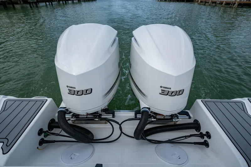  Yacht Photos Pics Twin Yamaha 300 engines on a 2020 Wellcraft 302 Fisherman boat, docked on water.