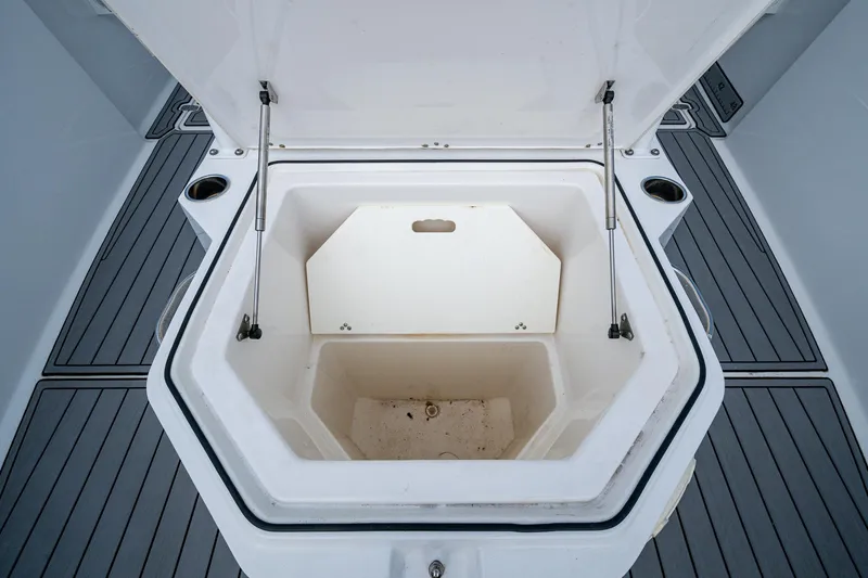  Yacht Photos Pics Open storage compartment on 2020 Wellcraft 302 Fisherman boat, featuring durable deck flooring.