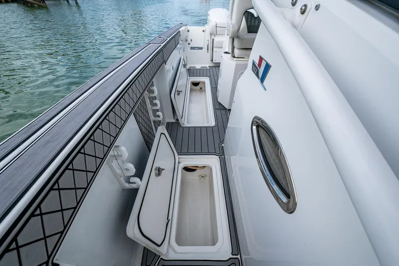  Yacht Photos Pics 2020 Wellcraft 302 Fisherman boat interior with open storage compartments and sleek design.