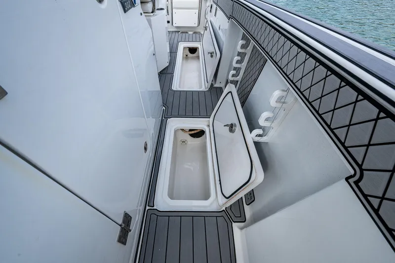  Yacht Photos Pics 2020 Wellcraft 302 Fisherman boat interior with open storage compartments.