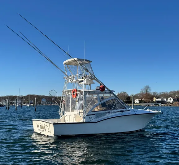 My Turn Yacht Photos Pics 2002 Carolina Classic 35 Express boat on calm water under clear blue sky.