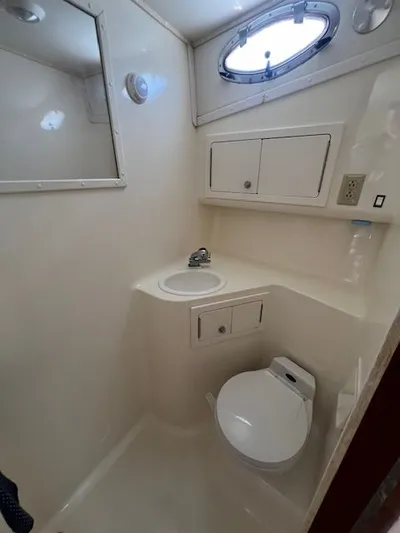 My Turn Yacht Photos Pics Bathroom interior of 2002 Carolina Classic 35 Express boat, featuring sink and toilet.
