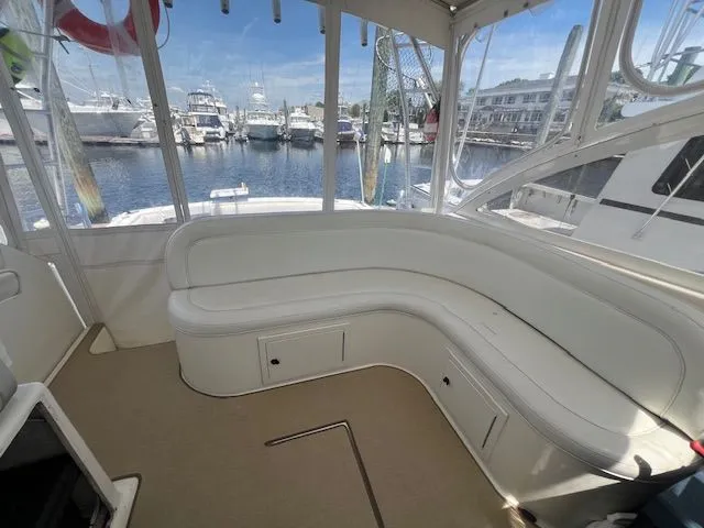 My Turn Yacht Photos Pics 2002 Carolina Classic 35 Express boat interior with white seating and marina view.