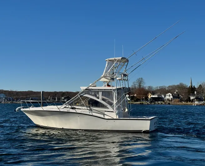 My Turn Yacht Photos Pics 2002 Carolina Classic 35 Express boat on water, clear sky, coastal background.