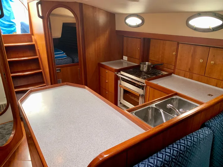 Ariadne Yacht Photos Pics Interior of 2004 ShearWater 45 yacht with wooden cabinetry and modern kitchen amenities.