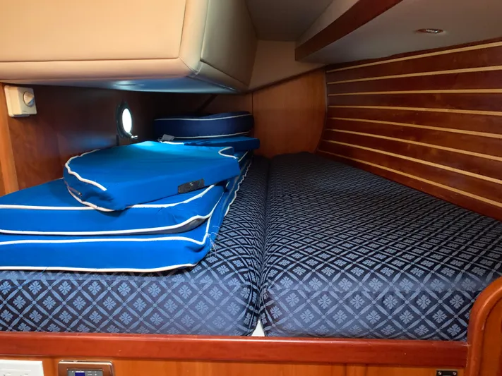 Ariadne Yacht Photos Pics Cabin interior of 2004 ShearWater 45 yacht with blue patterned bedding.
