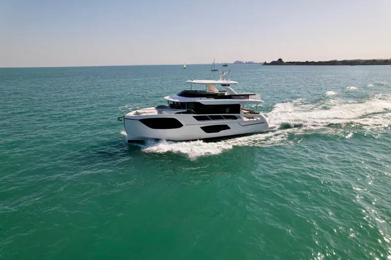 Wild Aces Yacht Photos Pics 2022 Absolute 64 Navetta yacht cruising on open sea under clear sky.