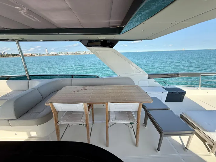 Wild Aces Yacht Photos Pics Luxurious 2022 Absolute 64 Navetta yacht deck with seating and ocean view.