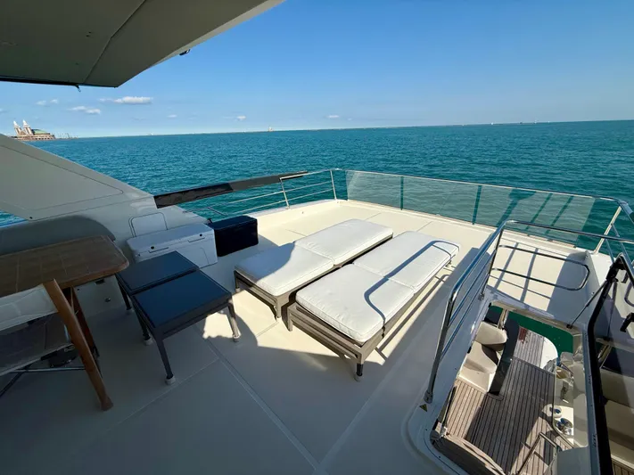 Wild Aces Yacht Photos Pics Luxurious deck of 2022 Absolute 64 Navetta yacht with sun loungers and ocean view.