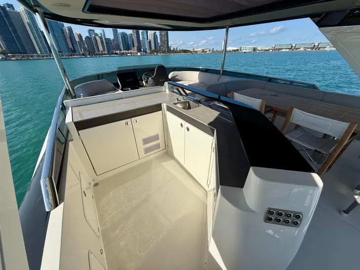 Wild Aces Yacht Photos Pics Luxurious 2022 Absolute 64 Navetta yacht with modern outdoor kitchen and stunning city skyline view.