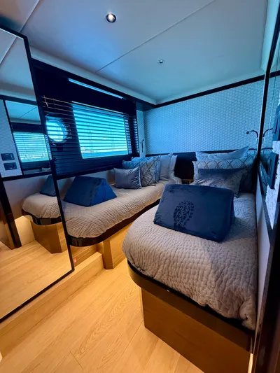 Wild Aces Yacht Photos Pics Luxurious cabin interior of 2022 Absolute 64 Navetta yacht with twin beds and elegant decor.