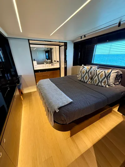 Wild Aces Yacht Photos Pics Luxurious bedroom interior on 2022 Absolute 64 Navetta yacht, featuring modern design and ocean view.
