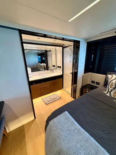 Wild Aces Yacht Photos Pics Luxurious bedroom and bathroom in 2022 Absolute 64 Navetta yacht, featuring modern design.