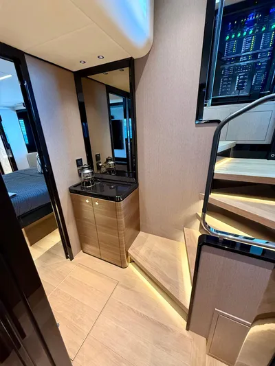 Wild Aces Yacht Photos Pics Luxurious interior of 2022 Absolute 64 Navetta yacht with modern staircase and sleek design.