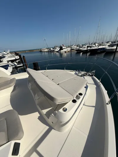 Wild Aces Yacht Photos Pics Luxury Absolute 64 Navetta yacht deck, 2022 model, docked at marina with clear blue sky.