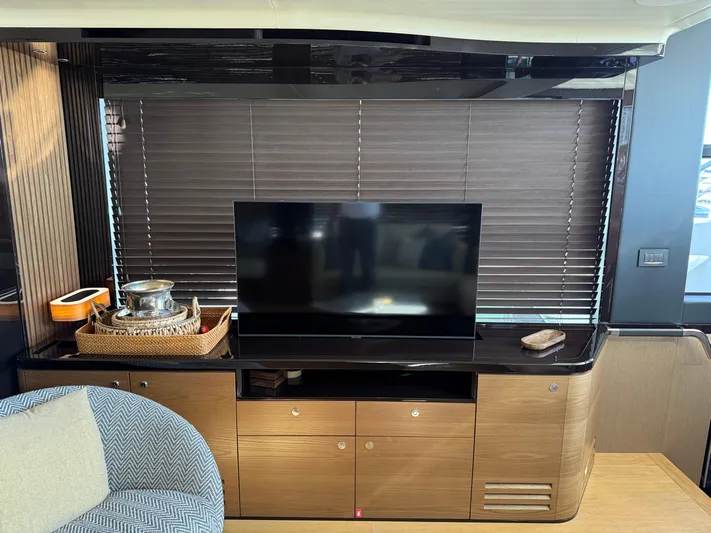 Wild Aces Yacht Photos Pics Luxurious interior of 2022 Absolute 64 Navetta yacht with TV and elegant decor.