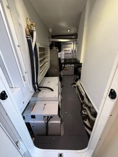 Wild Aces Yacht Photos Pics Engine room of 2022 Absolute 64 Navetta yacht, showcasing equipment and machinery.