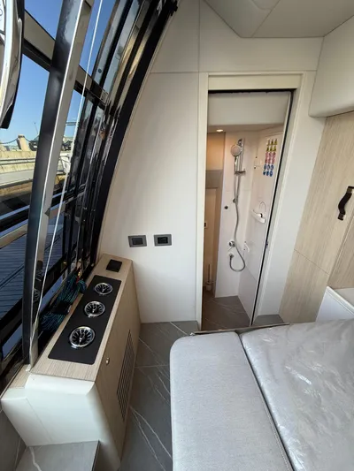 Wild Aces Yacht Photos Pics Luxurious interior of 2022 Absolute 64 Navetta yacht, featuring modern bathroom and sleek design.