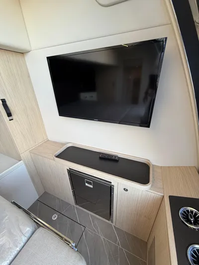 Wild Aces Yacht Photos Pics Interior of 2022 Absolute 64 Navetta yacht with TV and modern cabinetry.