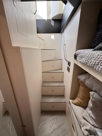 Wild Aces Yacht Photos Pics Interior staircase of 2022 Absolute 64 Navetta yacht with modern design and cozy bedding.