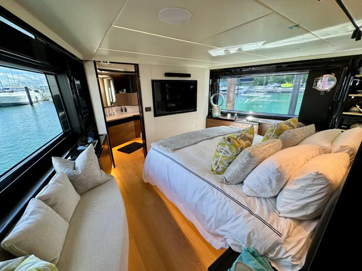 Wild Aces Yacht Photos Pics Luxurious bedroom interior of 2022 Absolute 64 Navetta yacht with waterfront views.
