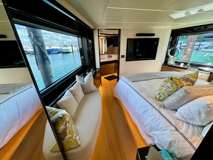 Wild Aces Yacht Photos Pics Luxurious interior of 2022 Absolute 64 Navetta yacht with elegant bedroom and marina view.