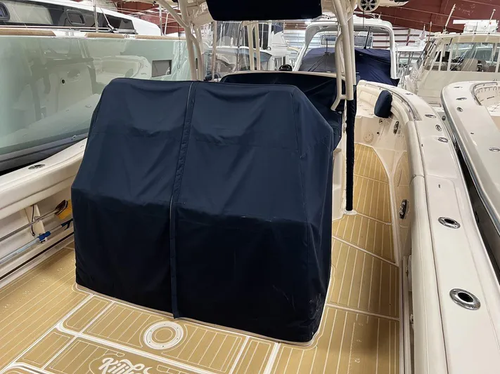  Yacht Photos Pics 2018 Grady-White Canyon 336 boat interior with covered console, teak flooring.