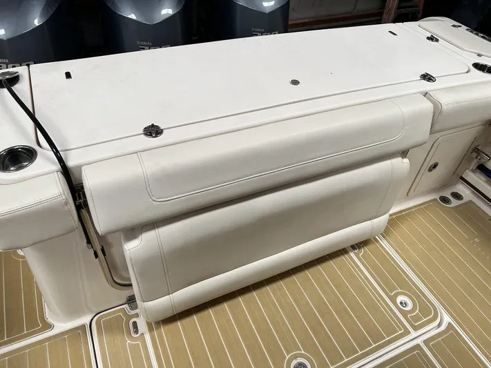  Yacht Photos Pics 2018 Grady-White Canyon 336 boat interior with cushioned seating and teak-style flooring.