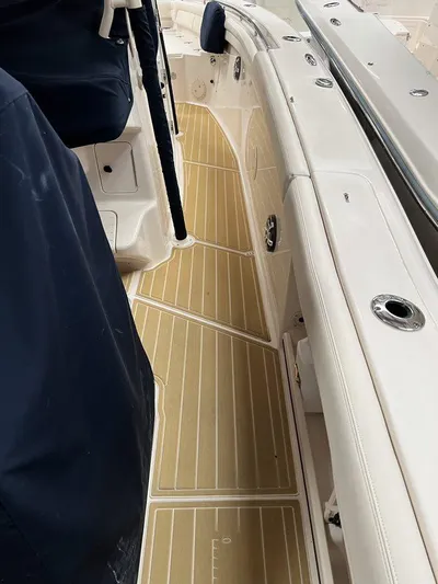 Yacht Photos Pics 2018 Grady-White Canyon 336 boat interior with teak flooring and white seating.