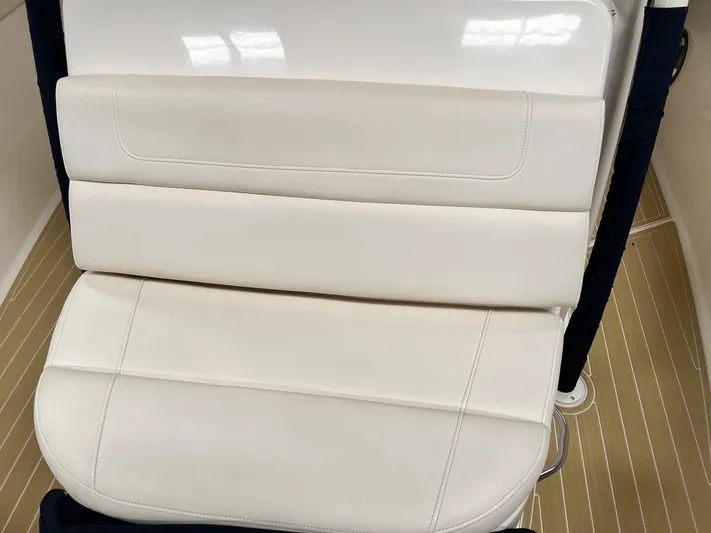  Yacht Photos Pics 2018 Grady-White Canyon 336 boat seat with white upholstery and wooden flooring.