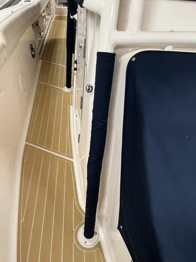  Yacht Photos Pics 2018 Grady-White Canyon 336 boat interior with teak flooring and cushioned seating.