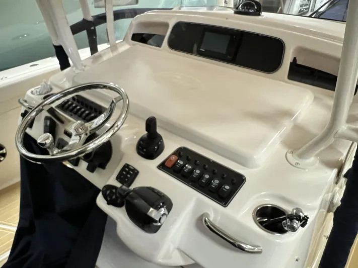  Yacht Photos Pics 2018 Grady-White Canyon 336 boat helm with steering wheel and control panel.