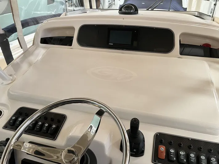  Yacht Photos Pics Helm of 2018 Grady-White Canyon 336 boat with steering wheel and control panel.
