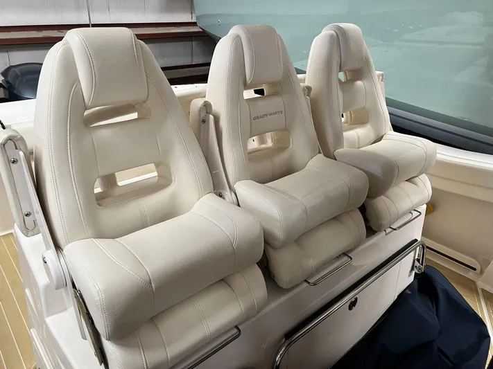  Yacht Photos Pics Three white cushioned seats on a 2018 Grady-White Canyon 336 boat.